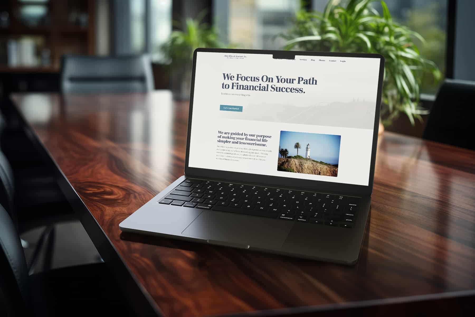 A laptop on a wooden table displaying a website titled "we focus on your path to financial success," featuring a slogan and an image of wind turbines.